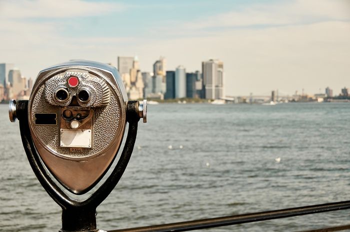 Public binoculars overlooking a city.