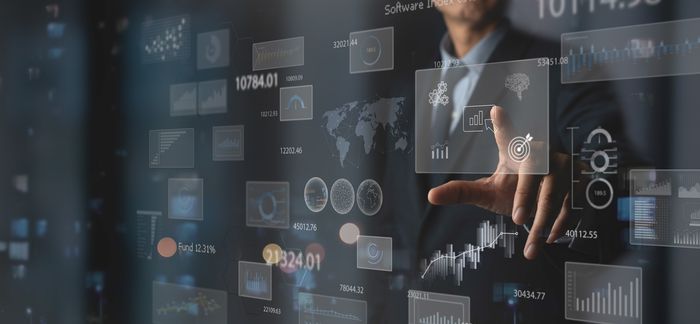 Someone managing multiple stocks on a futuristic touchscreen.